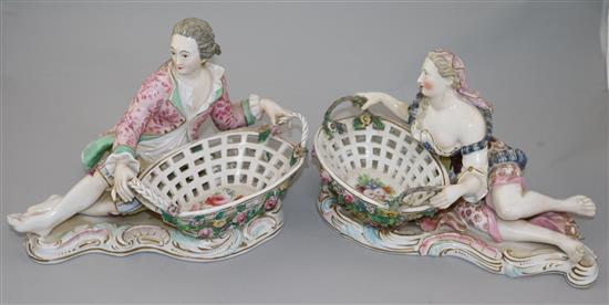 A pair of English porcelain figural sweetmeat dishes, mid 19th century, after the Meissen originals, length 29cm, restorations